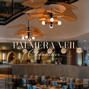 Palmera Veil Chandelier featuring elegant handwoven rattan mesh “leaf” panels arranged in a floating organic design. This luxury statement pendant chandelier casts a warm ambient glow above a sophisticated modern restaurant interior, blending tropical artistry, natural textures, and contemporary coastal elegance.